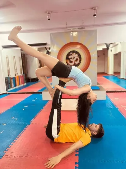 A beautiful expression of the "Reverse Bird" pose in acro yoga. The flyer opens their chest towards the sky, creating a wonderful heart-opening stretch supported by the base.