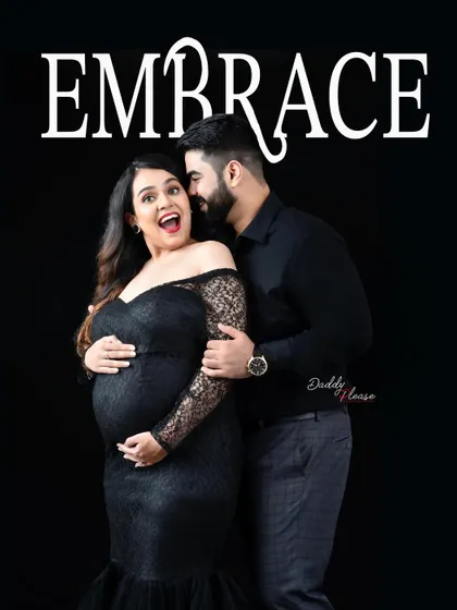 A fun and candid moment between a couple during their maternity shoot. The word "Embrace" is overlaid, perfectly capturing the joyful spirit of their pregnancy journey.
