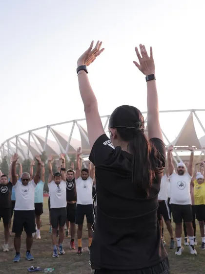 Leading a dynamic warm-up session. I teach runners to move away from static stretching before a run and focus on movements that activate key muscles and improve mobility.