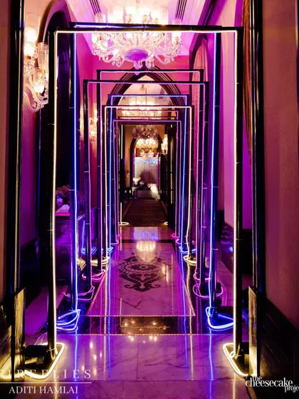 The entrance tunnel for the Sangeet, lined with glowing neon frames. This created a futuristic and high-energy welcome, setting the tone for the party inside.