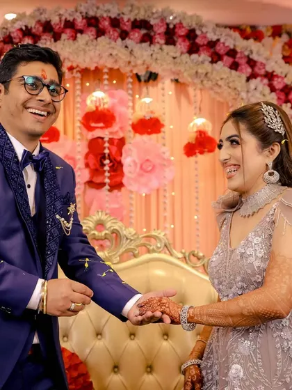 The joy of an engagement ceremony is perfectly captured in the couple's shared laughter and holding hands.