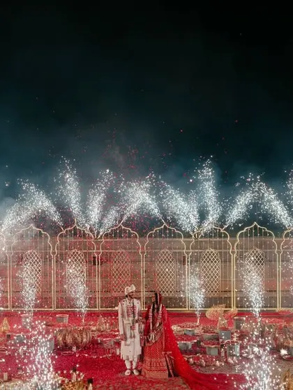 A dramatic Varmala moment with cold pyros creating a fountain of sparks.