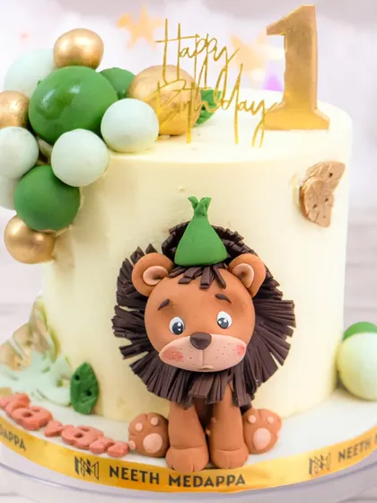 A close-up of the sweet, handcrafted lion topper. It's these little details that bring so much personality to a child's birthday cake.
