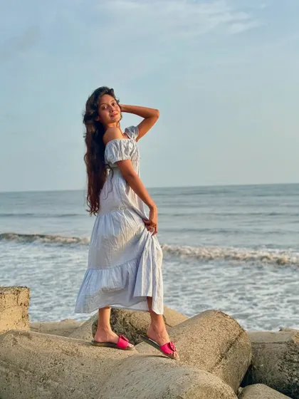 Posing in a summer dress by the ocean. My trips are the perfect opportunity to wear your favorite travel outfits and get some amazing photos.