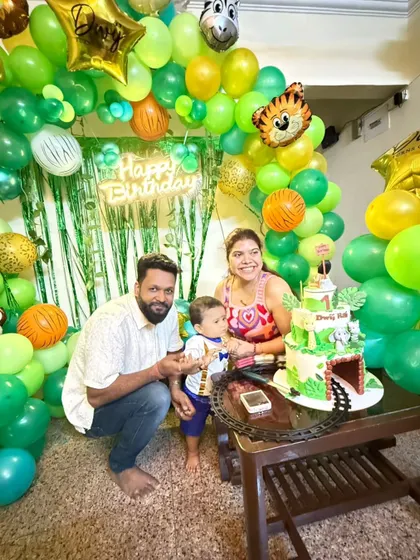 The happy family celebrating their son's first birthday with our Jungle Book-themed cake.