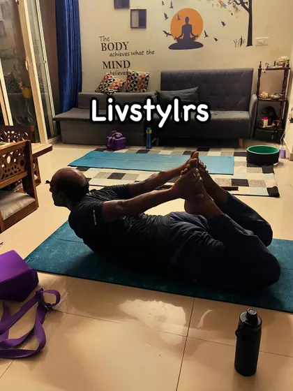 A client practices Dhanurasana (Bow Pose), a deep backbend that strengthens the entire back of the body and opens the chest and shoulders.