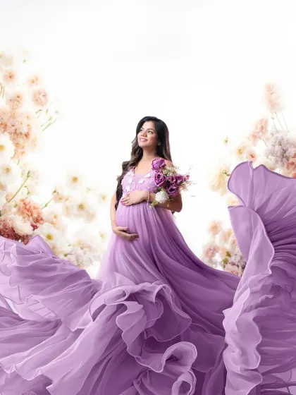 An ethereal portrait with a flowing lavender gown. The fabric seems to float on air, surrounded by a soft blur of flowers, creating a truly dreamy image.