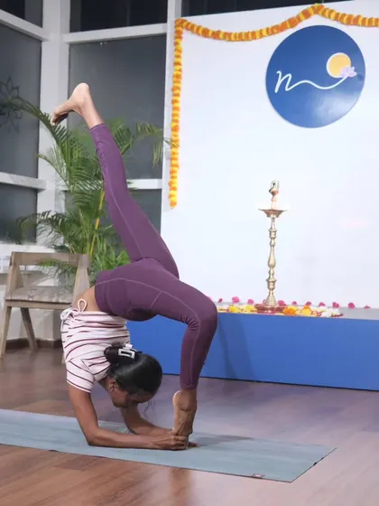 This student is in a deep forearm backbend, a variation of Vrischikasana (Scorpion Pose). This posture requires immense shoulder and spinal flexibility, and her form is a beautiful reflection of dedicated practice.