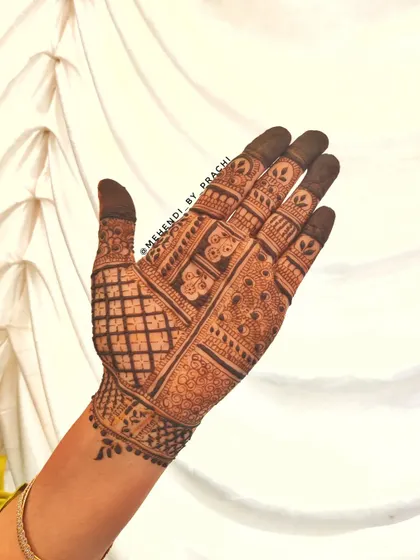 An intricate Indian design for the back of the hand. The mix of geometric grids and traditional patterns creates a rich and detailed look.