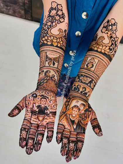 A stunning example of storytelling through mehendi. These full bridal arms feature multiple scenes, including a baby Krishna (Balkrishna) and a Radha-Krishna portrait.