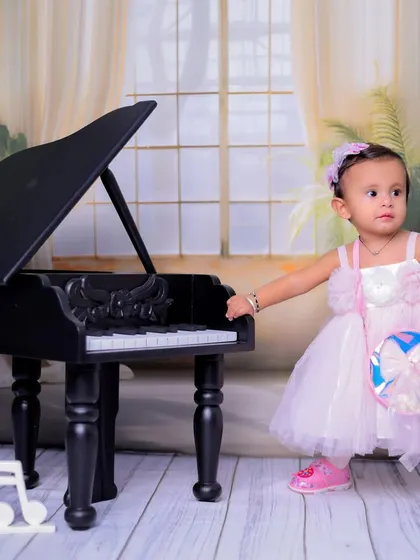 Ready for her performance. This shot includes musical note props to further enhance the theme and add a playful touch to the photograph.