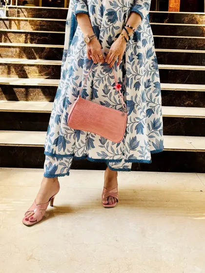 A detail shot of a blue and white floral kurta set, focusing on the pink accessories that add a lovely pop of color. This shows how I coordinate my entire look.