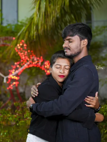 An intimate hug with soft, romantic lighting in the background. I aim to capture the quiet moments of affection between a couple.