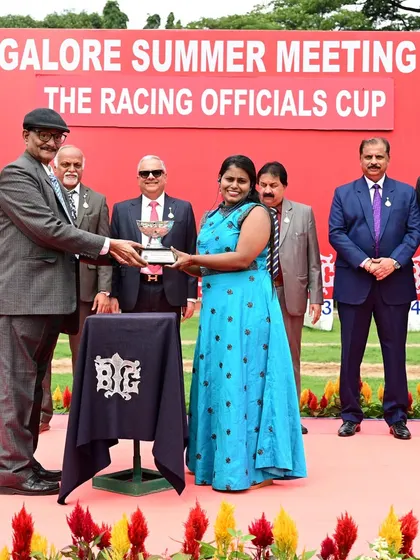 Mrs. Kokila.E receives The Racing Officials Cup from Mr. T. Raman, Advisor Racing, celebrating the victory of El Alamein.