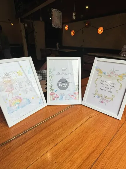 Another angle of the lovely framed fairy art, placed on a wooden table to welcome guests.