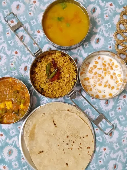 Today's special menu features tangy Puliyogre rice, creamy mutter paneer, simple dal, and cooling boondi raita. It's a delicious combination of flavors from across India.