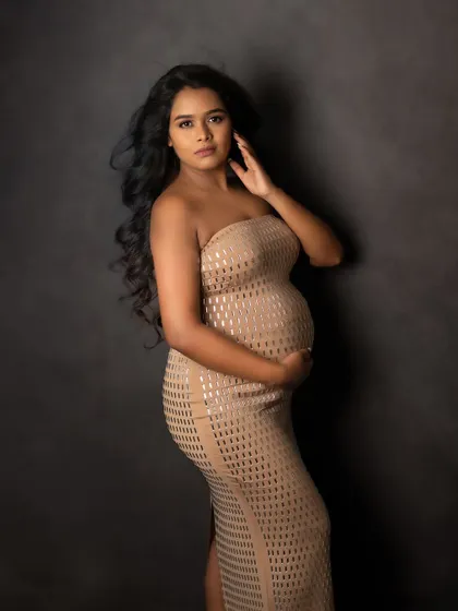 A confident and direct gaze. This portrait captures the strength and power of a woman about to become a mother.