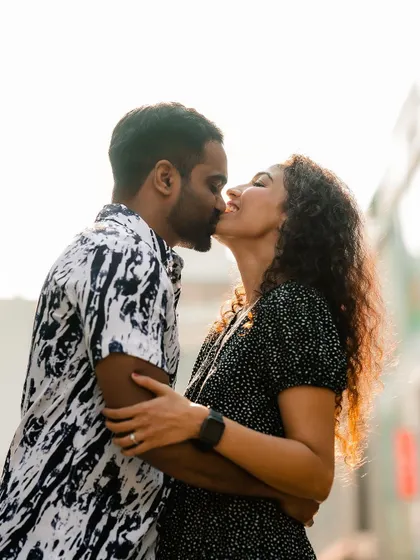 An intimate kiss shared by the couple during their city street photoshoot.