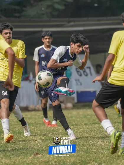 A player shows off his flair, controlling the ball with the outside of his boot in a crowded space.