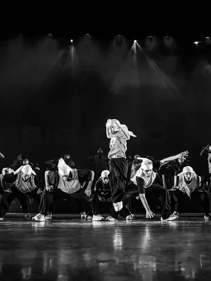 A black and white shot capturing the raw energy of a hip-hop showcase. Our performances are dynamic, artistic, and always unforgettable.