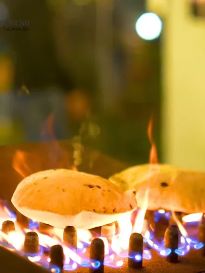 There's nothing like the taste of freshly made bread. Here, our chefs prepare rotis live on a specialized grill, ensuring they are served puffy and hot.