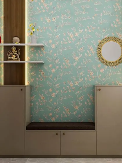A cozy foyer nook with a built-in bench and shoe cabinet. The floral wallpaper and small Ganesha idol create a warm and traditional welcome.