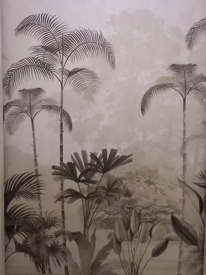 A monochrome tropical mural with palm trees, creating a subtle yet impactful feature. The grey tones give it a sophisticated and modern feel.