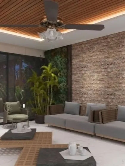 Interior view of a proposed outdoor room, featuring a vertical garden, exposed brick wall, and comfortable sofas. This design blends rustic and modern elements.