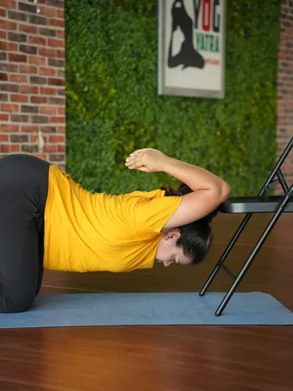 Using a chair to work on shoulder opening for backbends. This is an excellent and safe way to increase flexibility in the upper back and shoulders, which is essential for poses like wheel and kapotasana.
