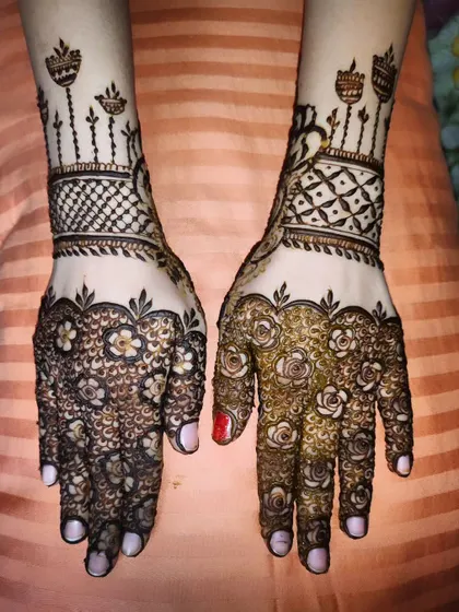 A unique design combining a floral-covered palm with a geometric wristband featuring diya motifs.