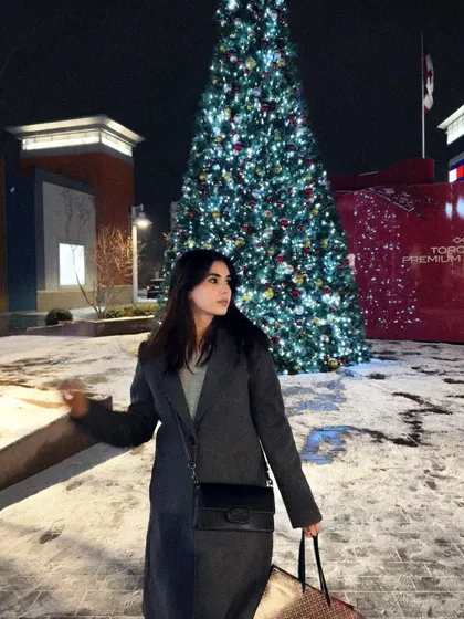 A candid moment, enjoying the festive holiday atmosphere in my long grey coat.