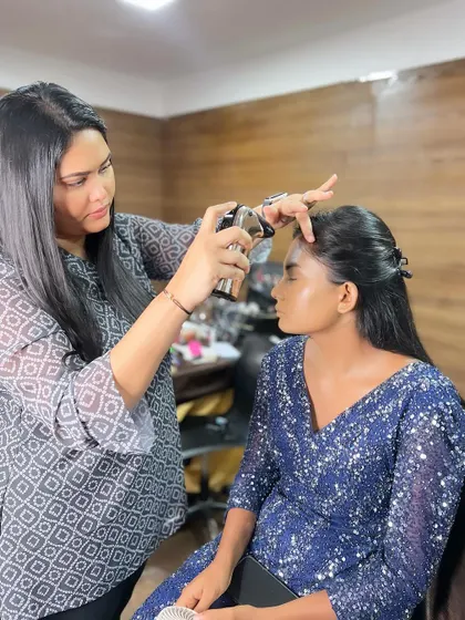 An airbrush makeup demonstration in progress during my Bangalore masterclass. I teach the latest techniques to ensure my students are industry-ready.