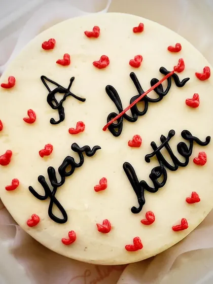 A bento cake for the millennials. This "A year older, a year hotter" message cake is a fun and cheeky way to celebrate a birthday.