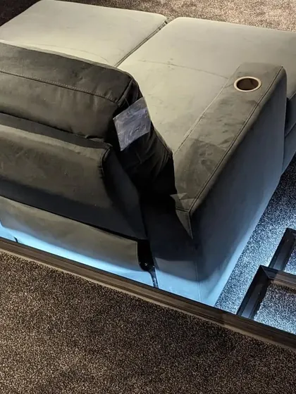 A detailed look at one of our chaise lounge recliners, featuring integrated step lighting. This safety feature is both practical and adds to the cool, modern aesthetic of the theater.