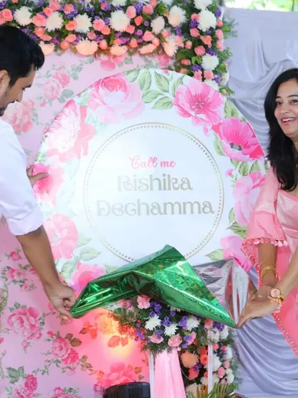 The moment of the name reveal is always so special. Here, the family unveils the baby's name on a custom-designed floral board. It’s a joy to create these memorable moments.