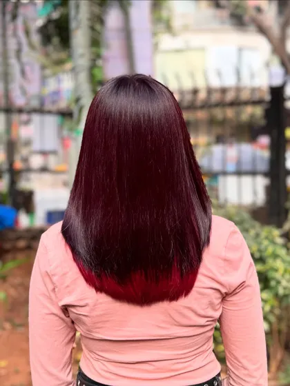 A rich, deep burgundy with a hint of brighter red at the tips. This color looks incredibly luxurious on straight, glossy hair and is one of my favorite looks from this year.