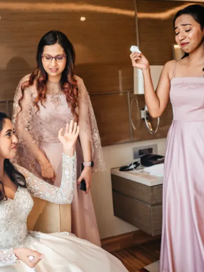 The bride comforts her emotional bridesmaid. These moments of friendship and support are just as important as the main events.