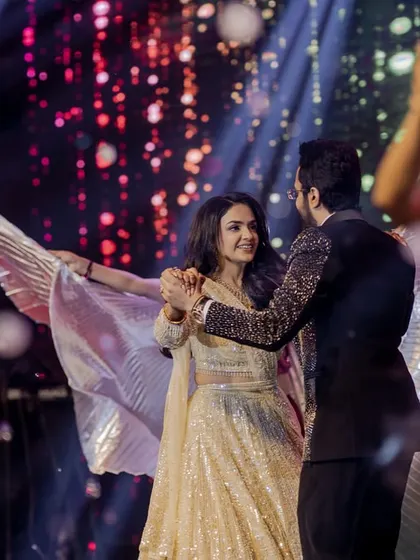 Using props like wings can add a touch of drama and elegance to a couple's dance. This moment looks like it's straight out of a movie.