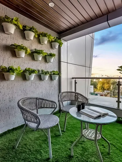 A simple and modern setup for two. This glass-topped table and woven chairs are perfect for a morning coffee or working from home, with a view. The wall-mounted planters are a great space-saving solution for adding greenery.
