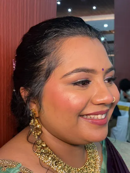 A close-up profile of this minimal makeup look. The blush is blended seamlessly for a natural flush, and the skin looks healthy and glowing.