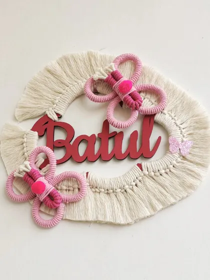 A client wanted a butterfly theme instead of a rainbow for this name hanging, and I loved the idea. This piece for "Batul" features two pink macrame butterflies.