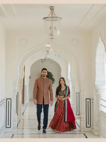 A confident and stylish portrait of the couple walking through the elegant corridors of the Hyatt Regency Jaipur.