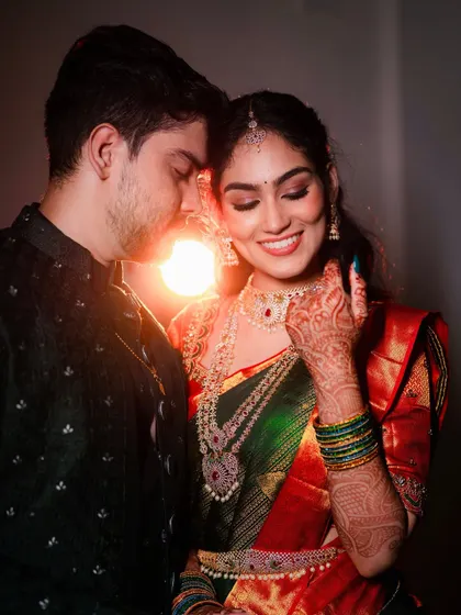 A beautiful, candid moment between the couple. My goal is always to create a makeup look that is not only stunning in photos but also durable and comfortable enough to be forgotten, allowing for genuine moments like this one.