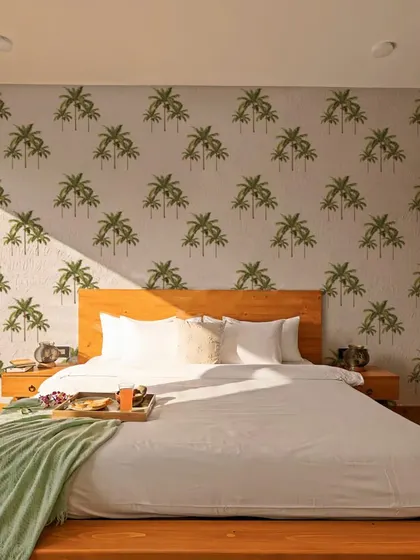 Our Watercolor Palm Tree wall stickers create a beautiful and serene feature wall in this bedroom. The soft watercolor design is perfect for a peaceful and relaxing atmosphere.