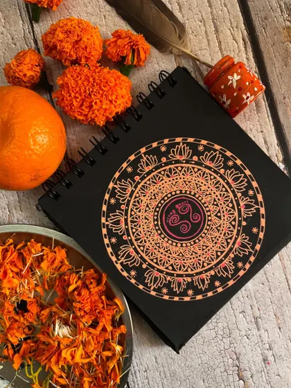 The orange Navratri mandala styled with fresh marigold flowers.