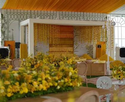 A view across the flower-filled tables towards the main Haldi stage.