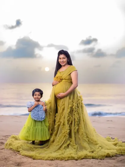 A mother and daughter sharing a golden moment by the sea. This family maternity session captures the beautiful bond that already exists while celebrating the new life on the way.