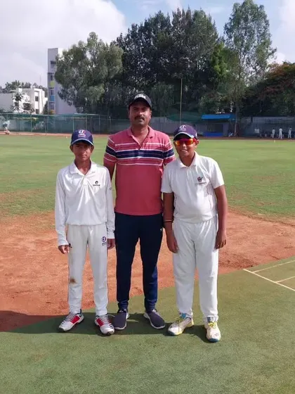 A coach with two U-12 players, showcasing our commitment to mentoring the next generation.