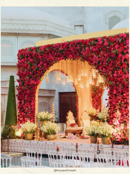 A close-up of the magnificent floating mandap, framed by a wall of red roses and accented with hanging lights, creating a breathtaking focal point for the ceremony.