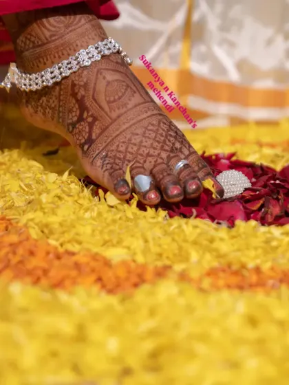 A close-up of a beautiful dark stain on the feet. The intricate patterns look even more stunning when the color fully develops, as seen here against a bed of flower petals.
